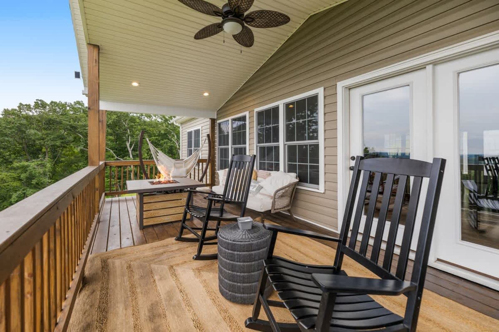 Covered porch with rocking chairs, a hammock, and ridge views